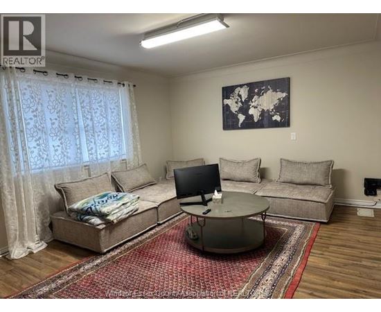 A living room with a couch, a coffee table, and a television.
