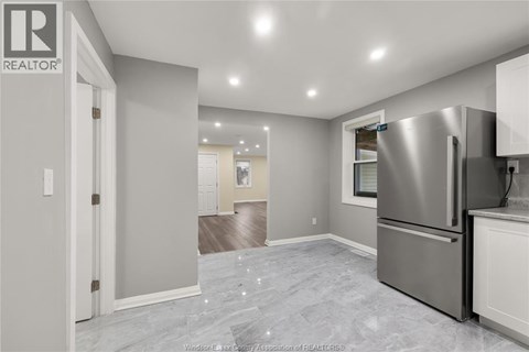 A kitchen with a refrigerator and a countertop.