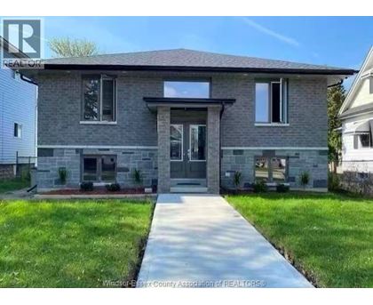 A house with a grey front and a white garage door.
