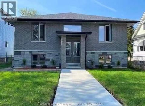 A house with a grey front and a white garage door.