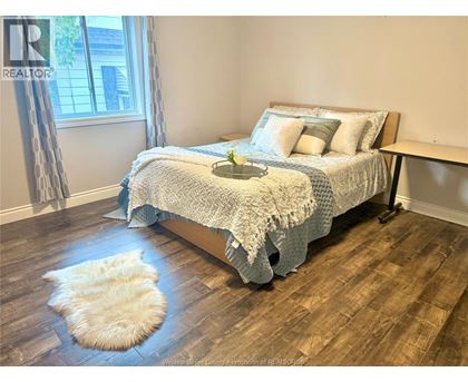A bedroom with a large bed and a window.