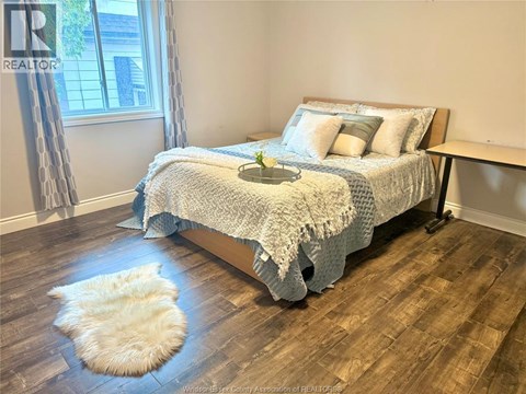 A bedroom with a large bed and a window.