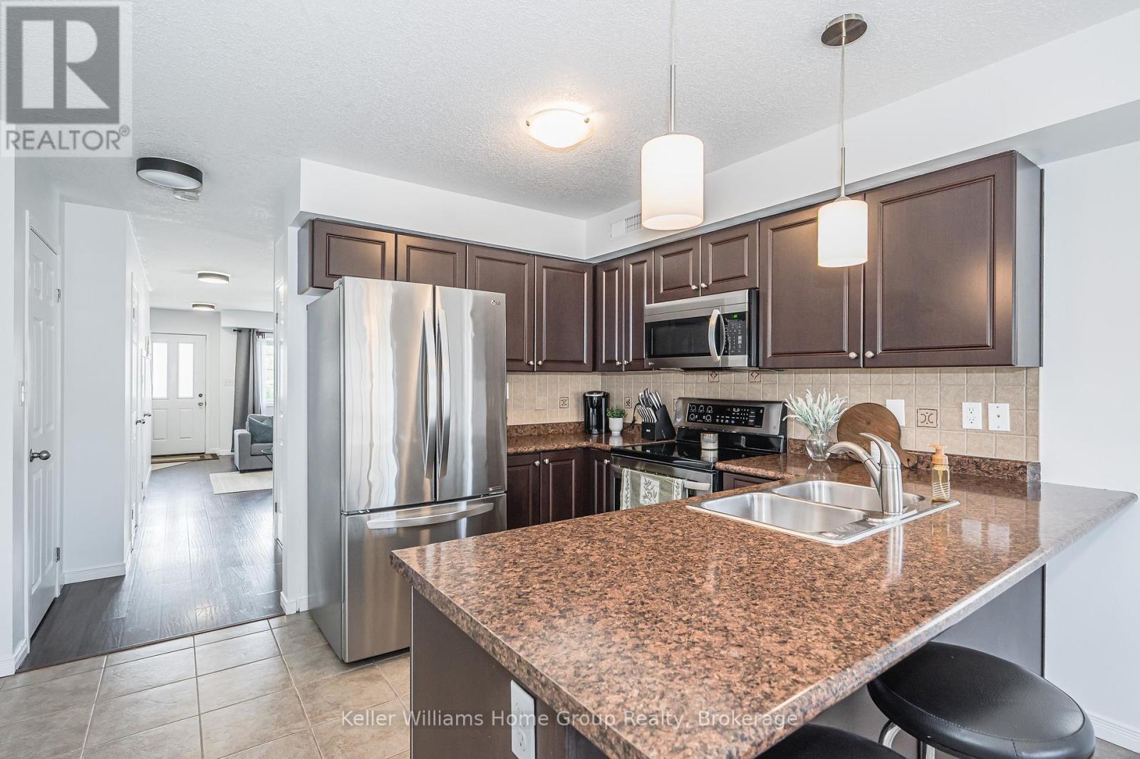 A kitchen with brown cabinets and a granite counter top.
