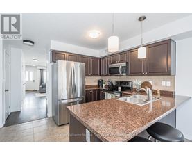 A kitchen with brown cabinets and a granite counter top.
