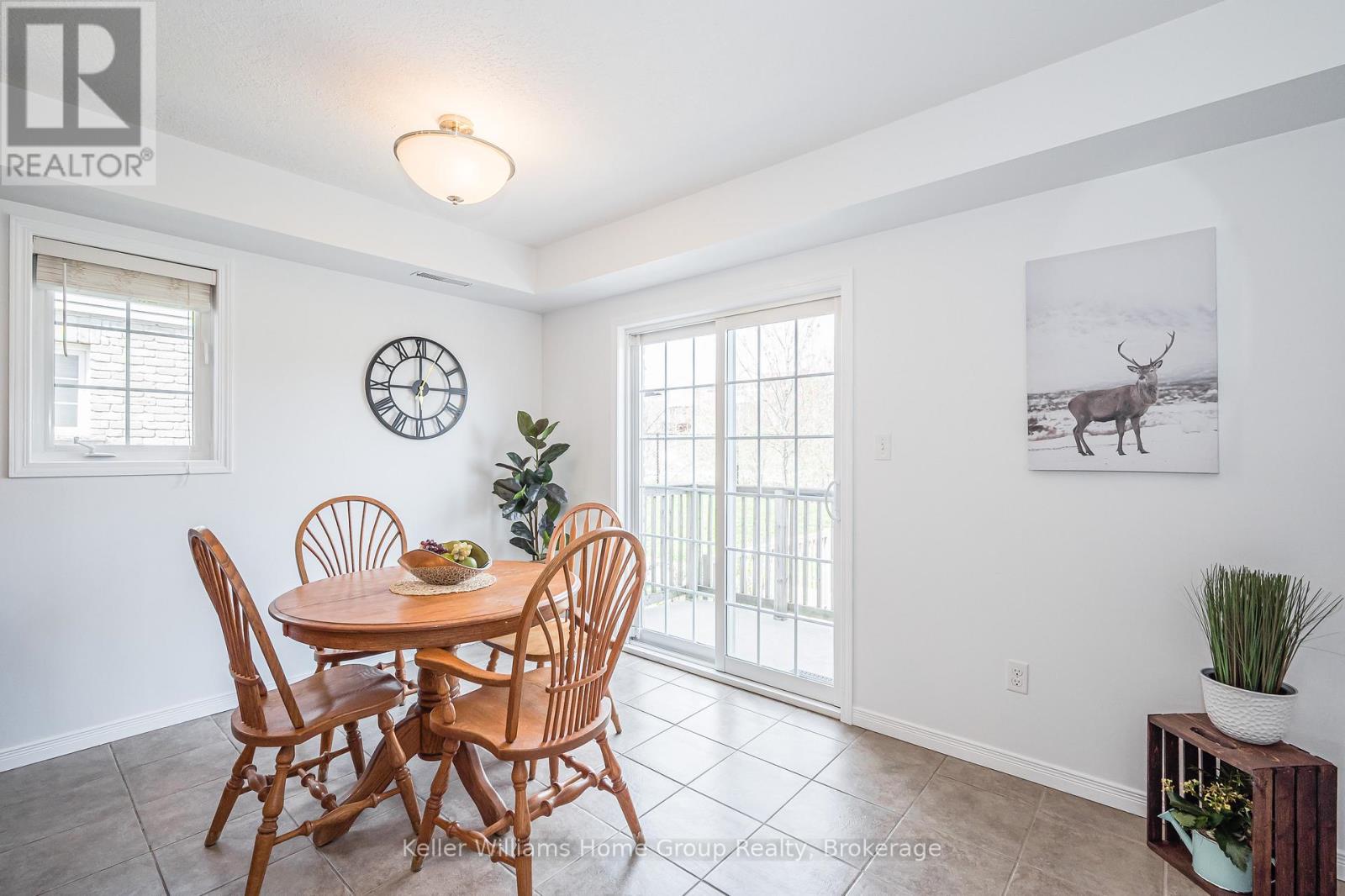 A dining room with a wooden table and chairs.