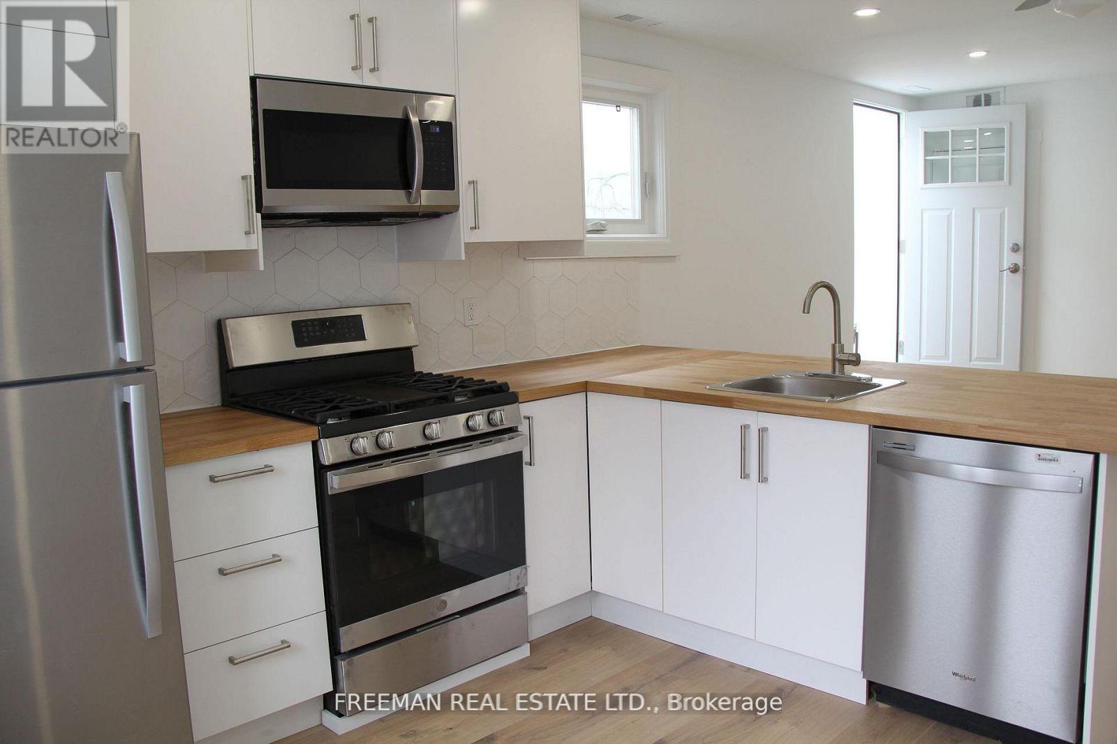 A kitchen with white cabinets and stainless steel appliances.