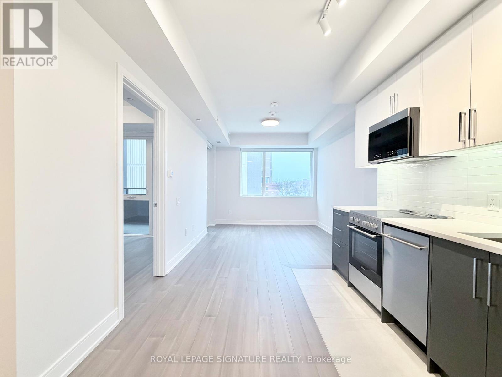 A kitchen with a microwave on the counter.