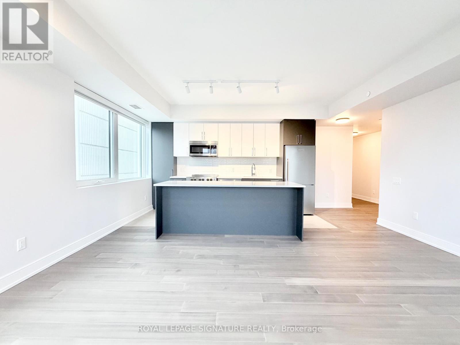 A spacious kitchen with a large island in the middle.