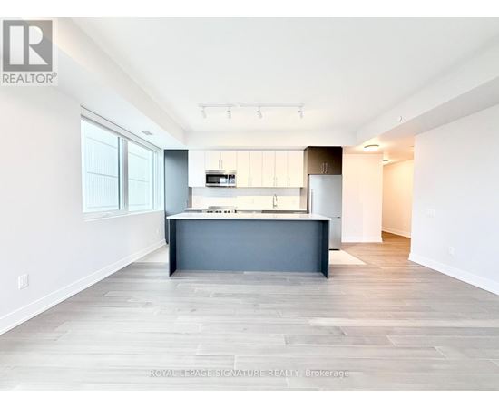 A spacious kitchen with a large island in the middle.