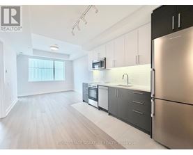 A kitchen with stainless steel appliances and white cabinets.