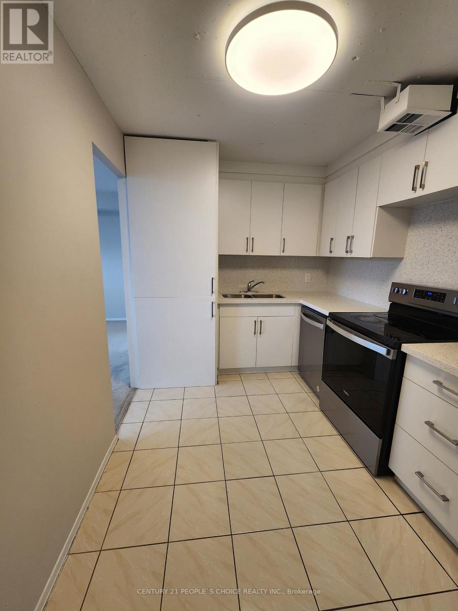 A kitchen with white cabinets and black appliances.