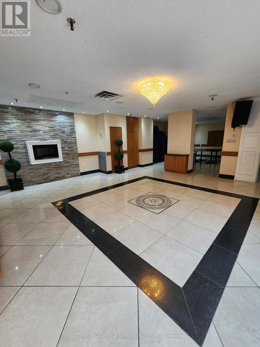 A spacious room with a stone wall and a television.