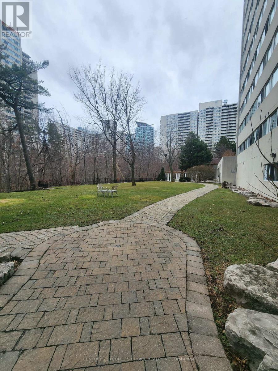A brick walkway leads through a grassy area.