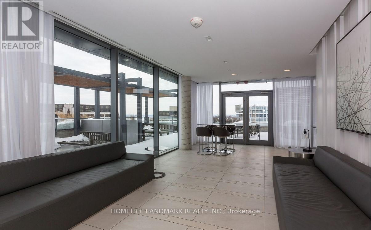 A modern living room with a view of the outside through large windows.