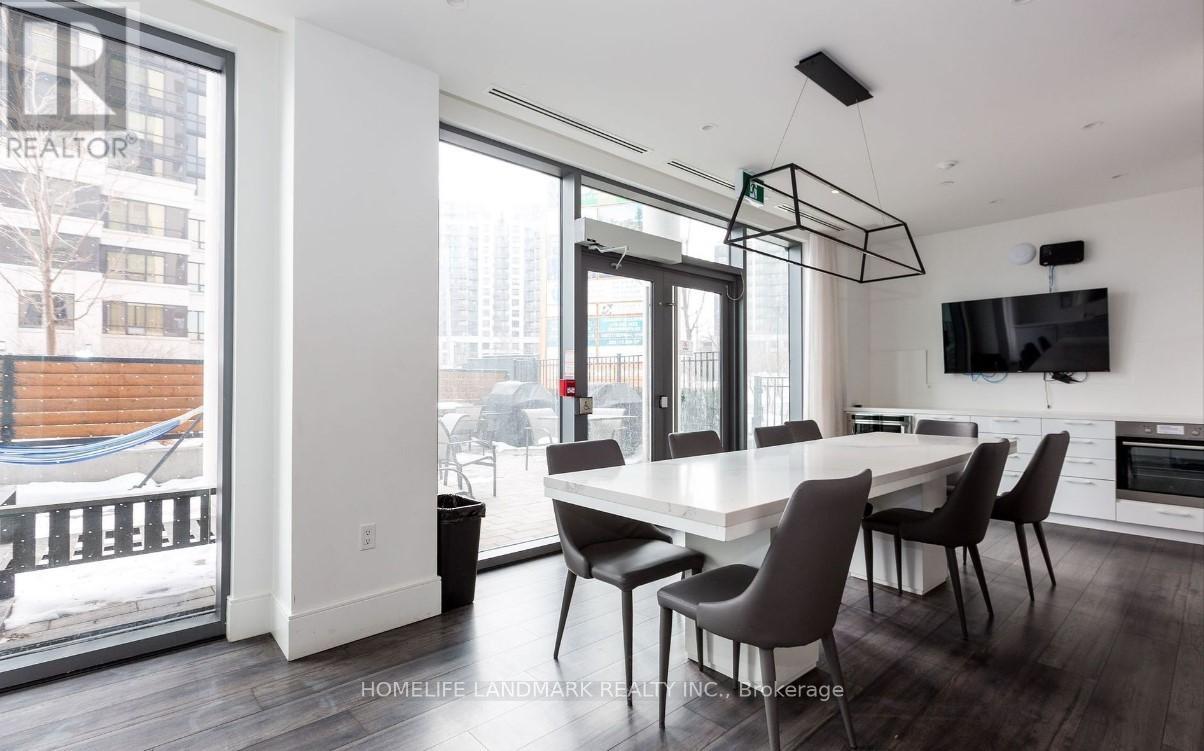 A modern dining room with a large table and chairs.