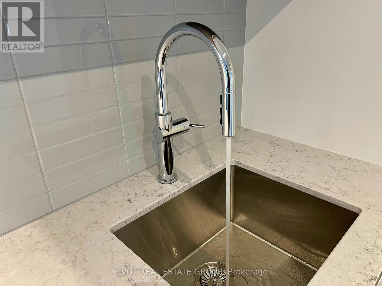 A kitchen sink with a chrome faucet.