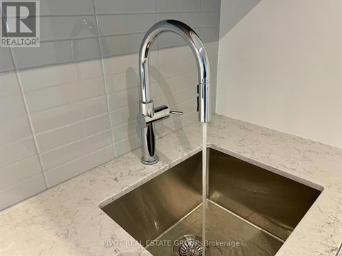 A kitchen sink with a chrome faucet.