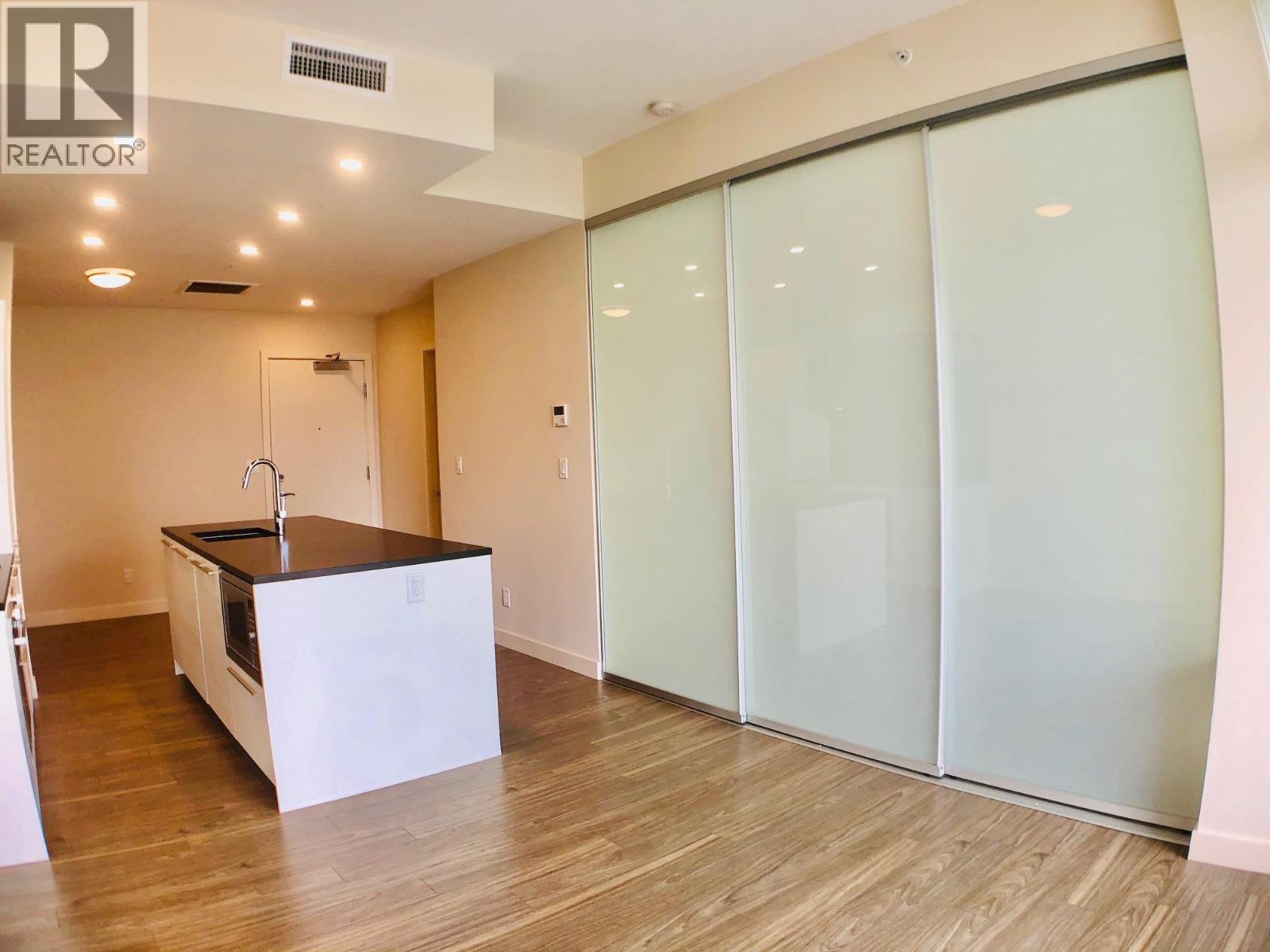 A modern kitchen with a sink and a countertop.