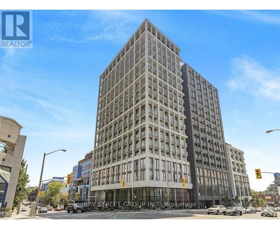 A tall building with many windows is located on Bay Street.