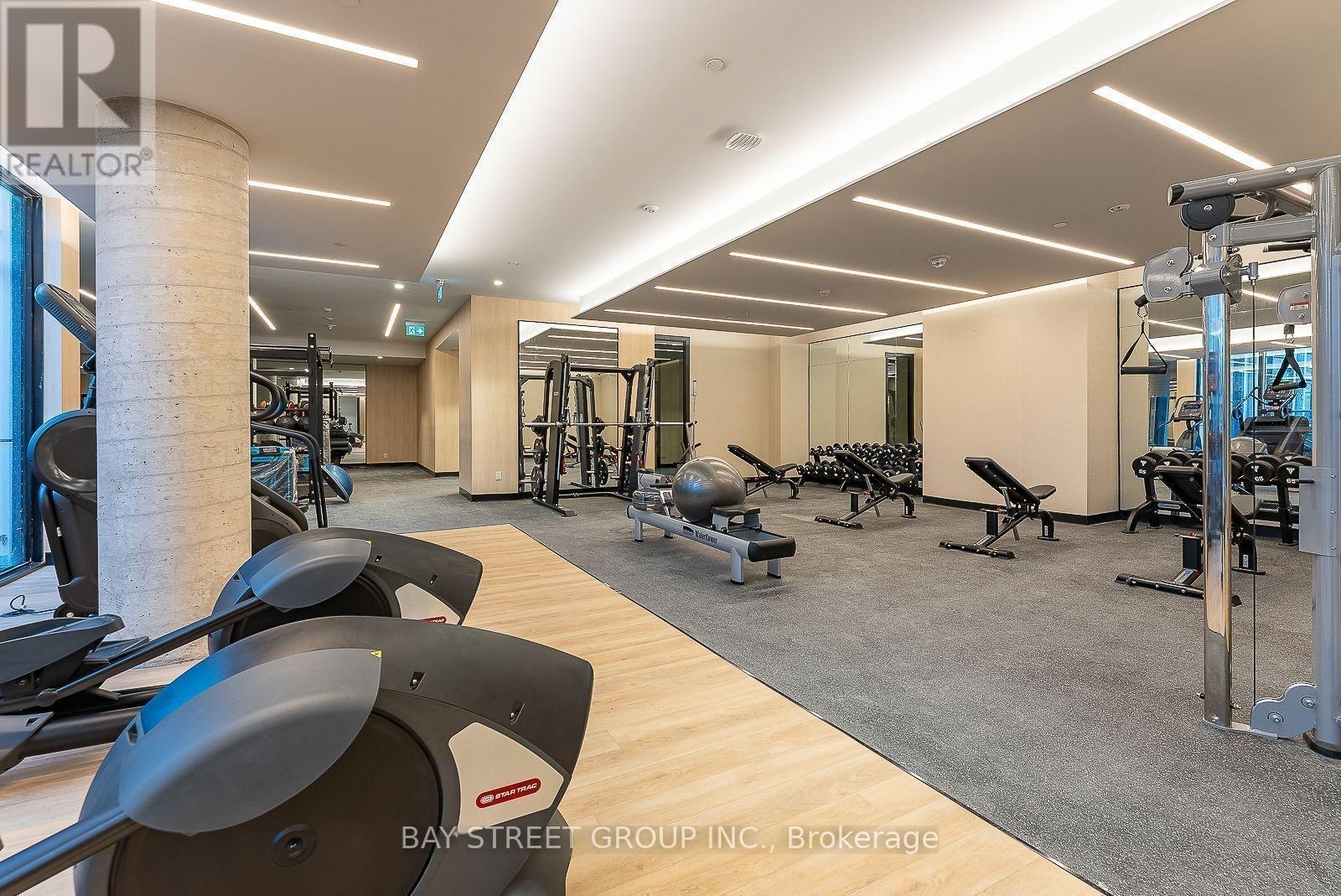 A gym with a variety of equipment including treadmills, weights, and exercise machines.