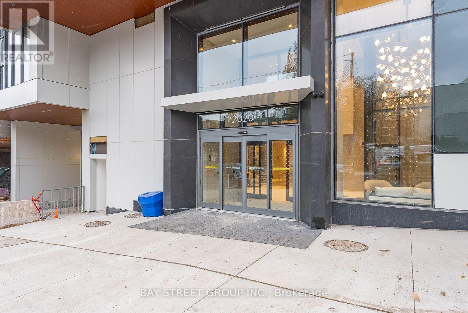 The entrance to a building with a glass door and a sign above it.