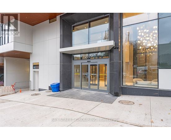 The entrance to a building with a glass door and a sign above it.