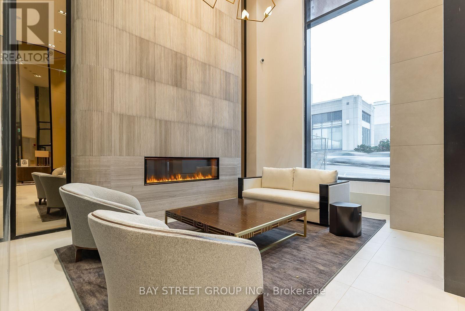 A modern living room with a fireplace and a glass door.