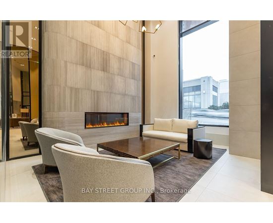 A modern living room with a fireplace and a glass door.