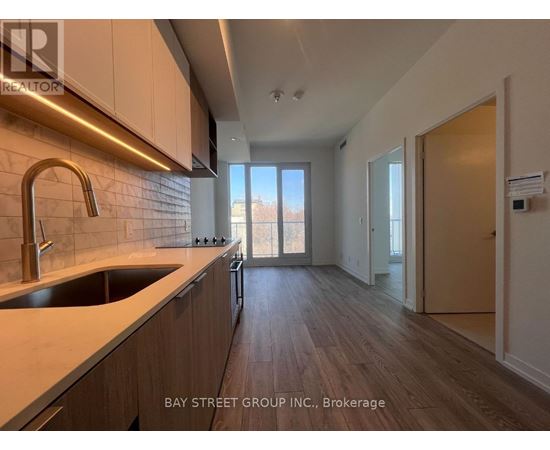 A kitchen with a sink and a window.