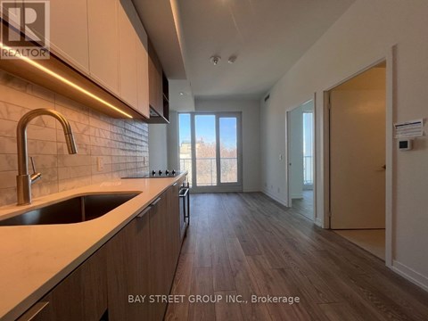 A kitchen with a sink and a window.