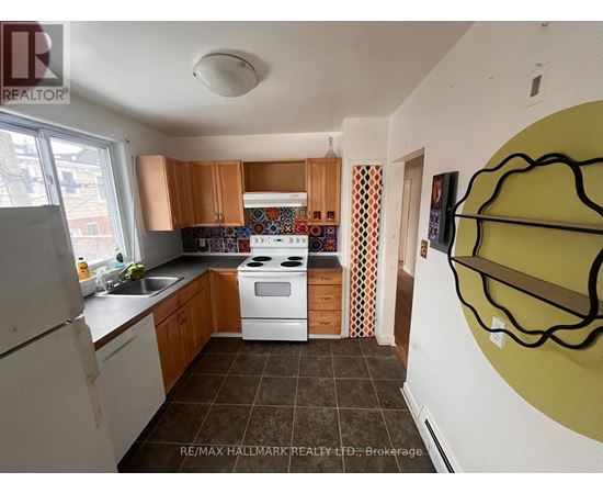 A kitchen with a white stove top oven and white refrigerator.