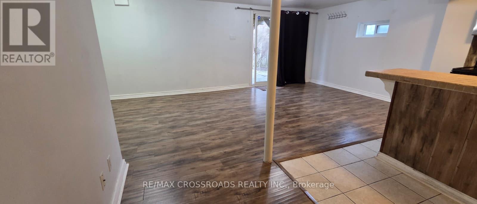 A realtor's office with a wooden floor and a white wall.