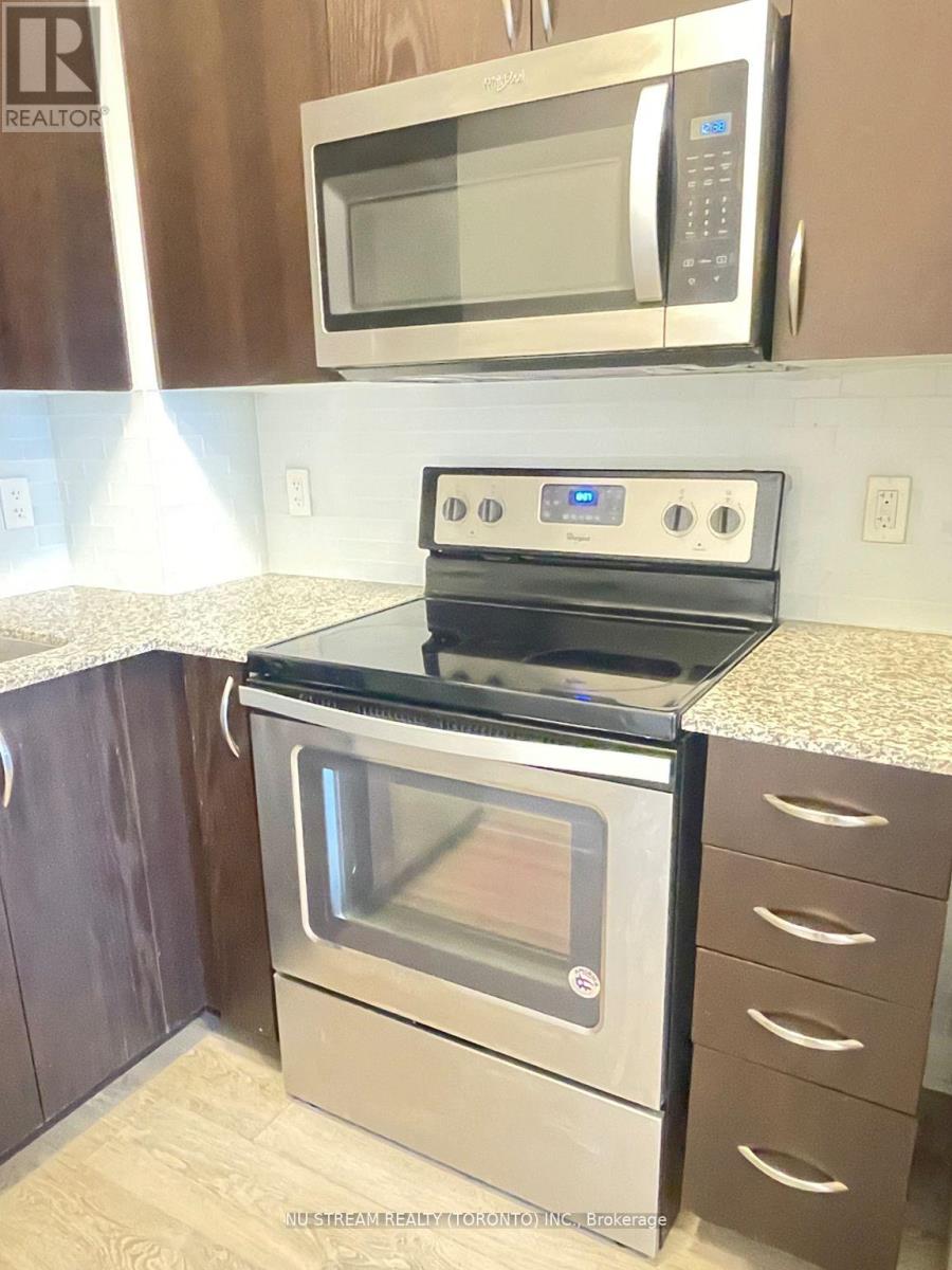 A stainless steel oven with a microwave above it.