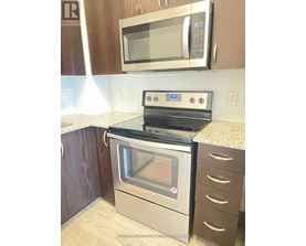 A stainless steel oven with a microwave above it.