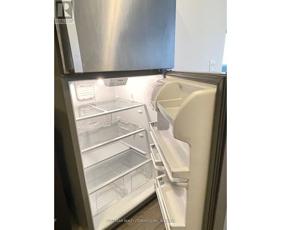 A stainless steel refrigerator with its door open and shelves visible.