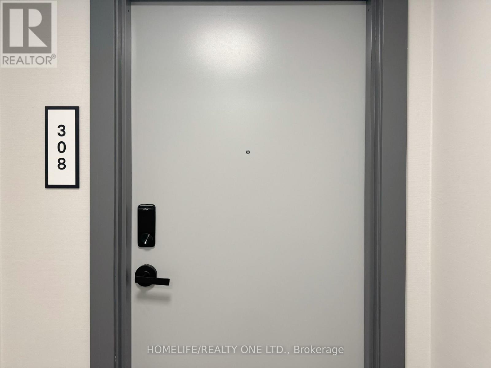 A door with a black handle and a number 308 on the wall.