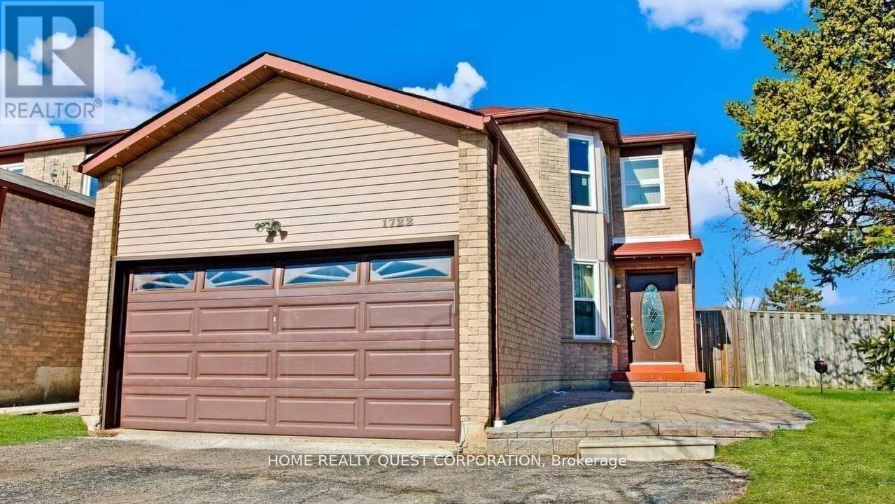 A two-story house with a brown garage door is for sale.