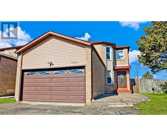 A two-story house with a brown garage door is for sale.