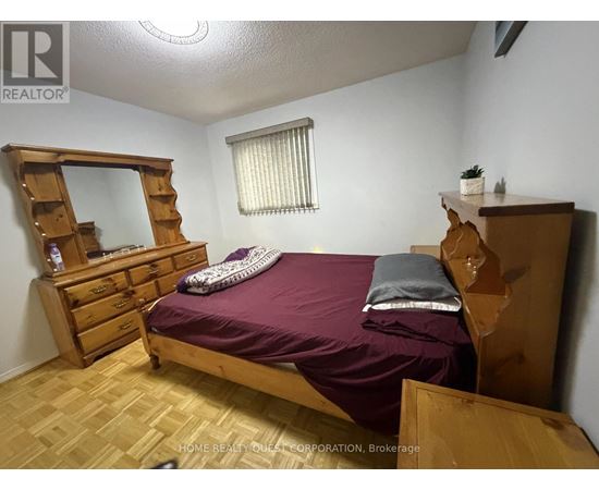 A bedroom with a bed, dresser, and mirror.
