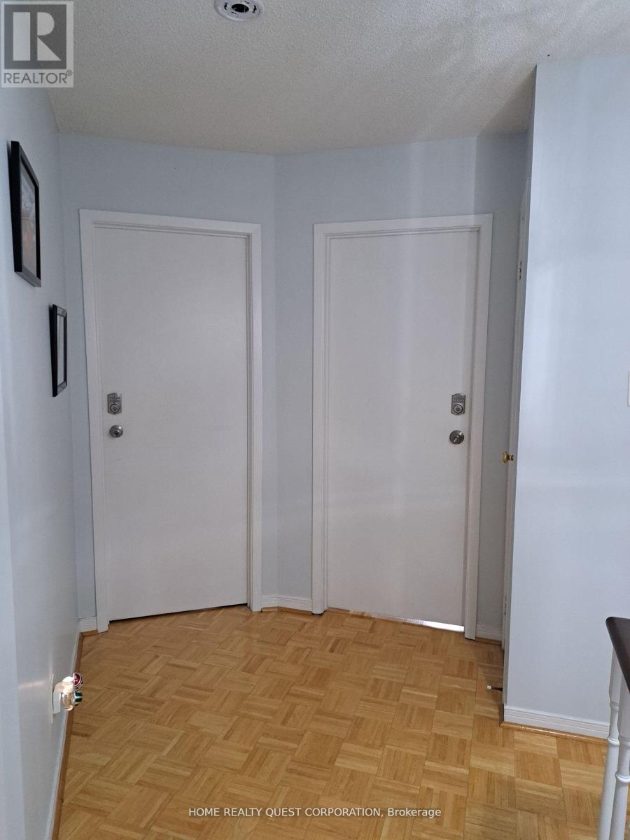 A room with two white doors and a wooden floor.