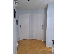 A room with two white doors and a wooden floor.