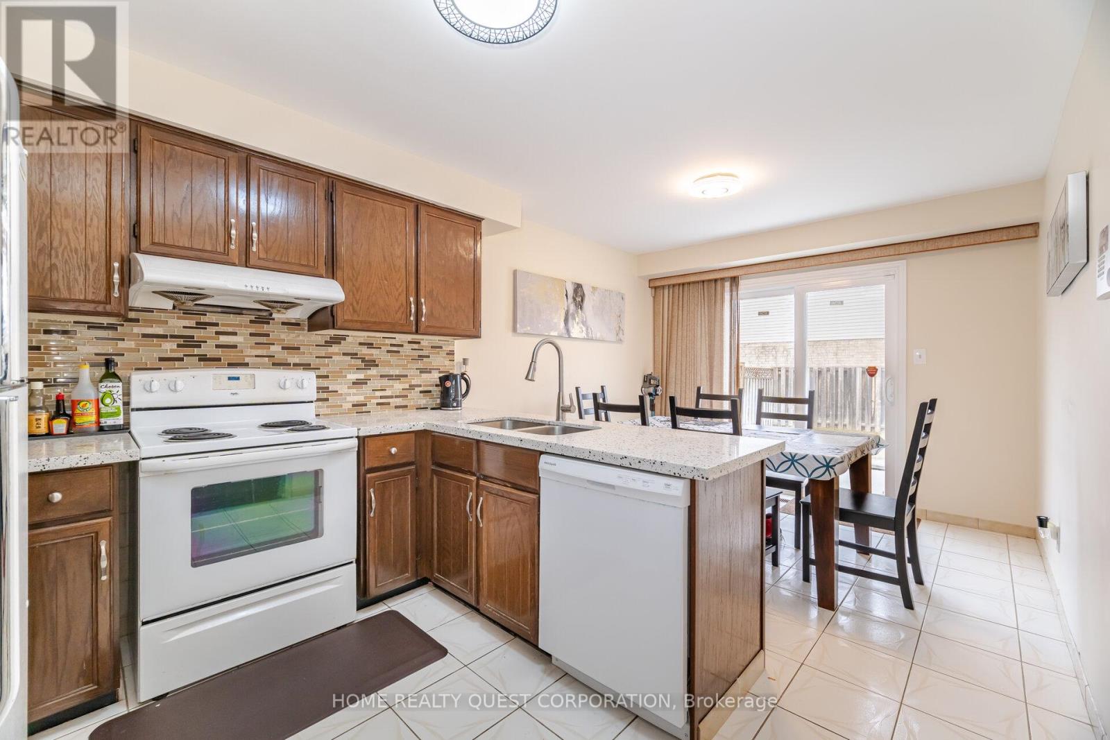 A kitchen with a white stove top oven and a white dishwasher.