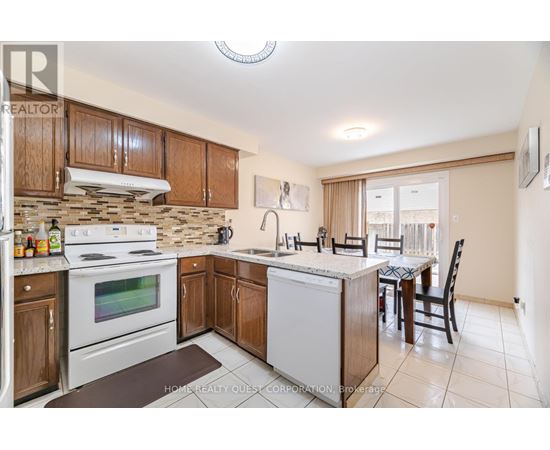 A kitchen with a white stove top oven and a white dishwasher.