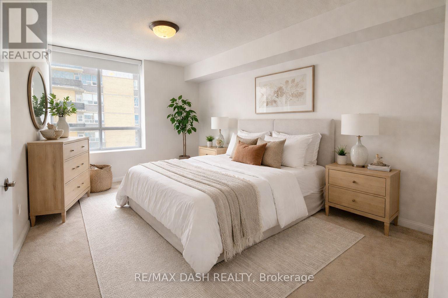 A bedroom with a large bed, a nightstand, and a dresser.