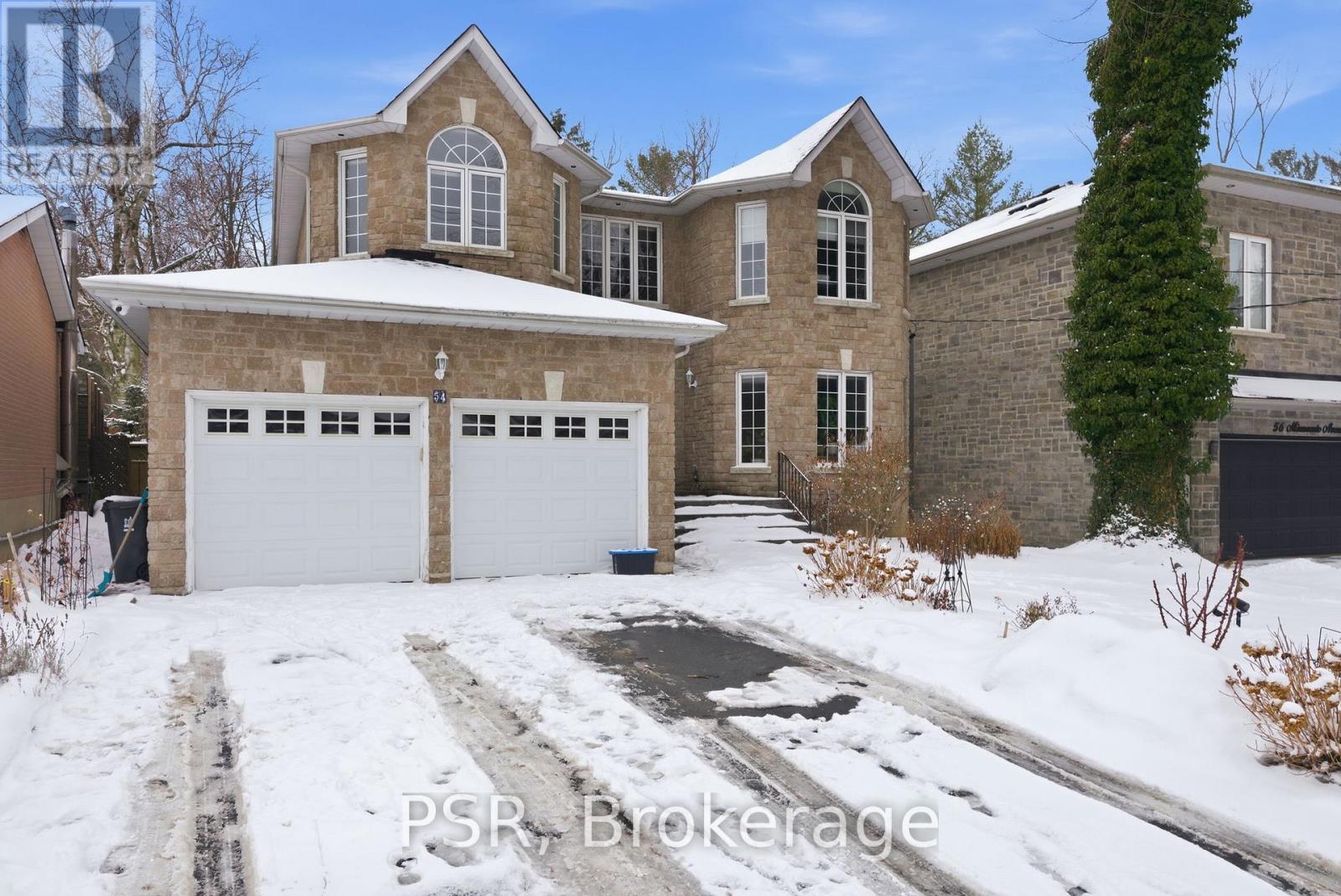 A house with a garage and driveway covered in snow.
