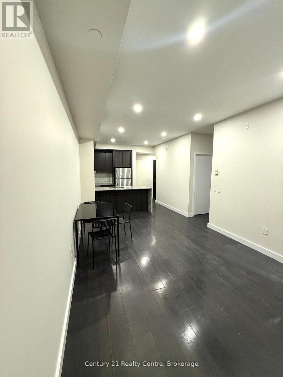 A spacious room with a dining table and chairs.