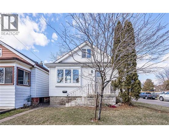 A house with a tree in front of it.