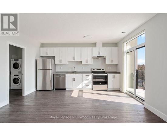 A modern kitchen with white cabinets and stainless steel appliances.
