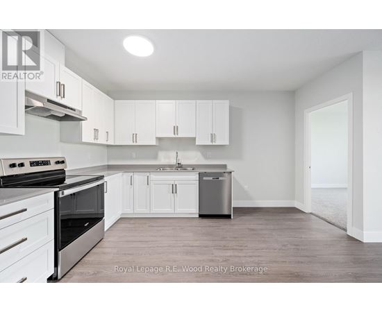 A white kitchen with a stove top oven and a dishwasher.