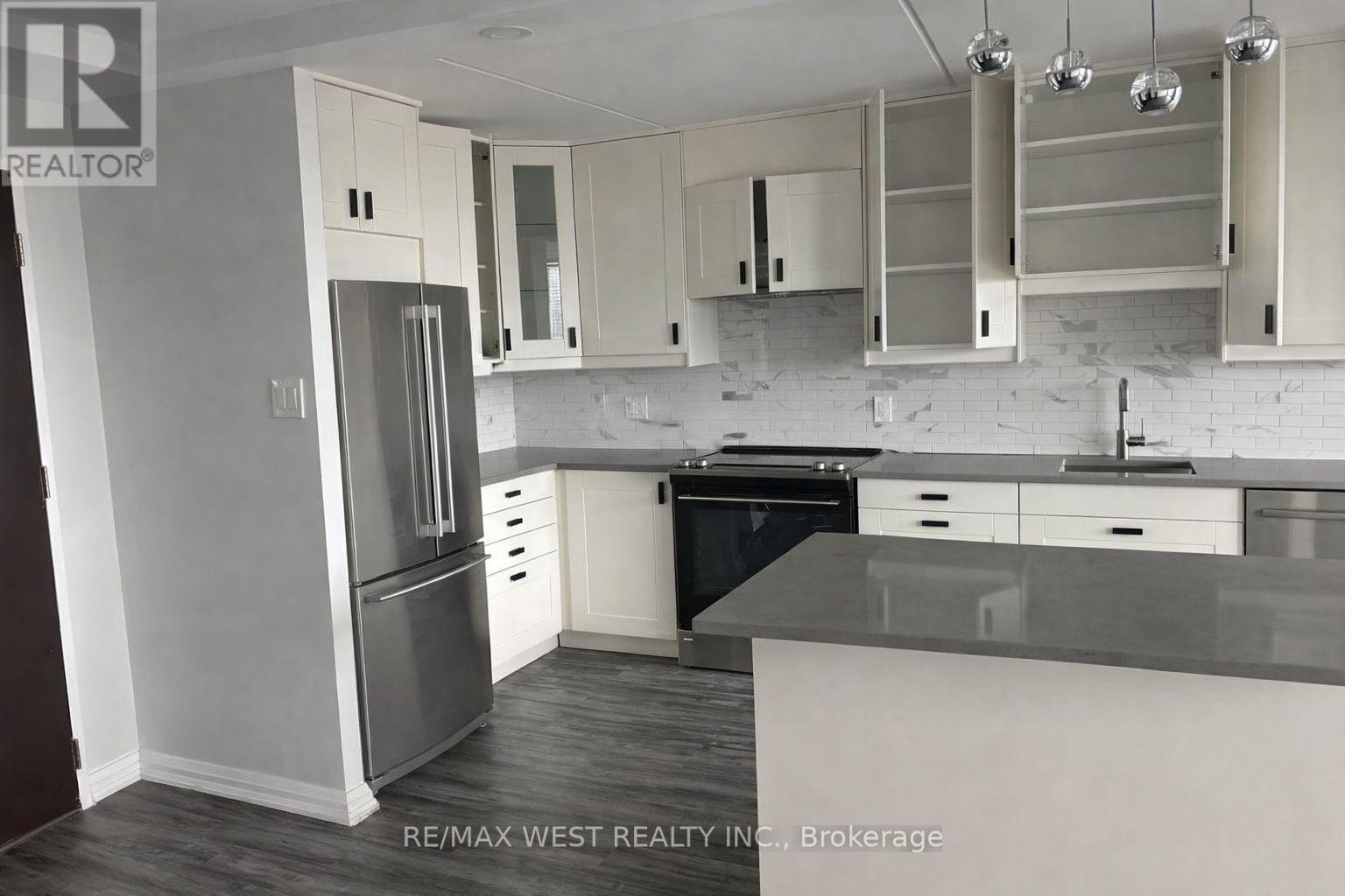 A kitchen with white cabinets and a black dishwasher.